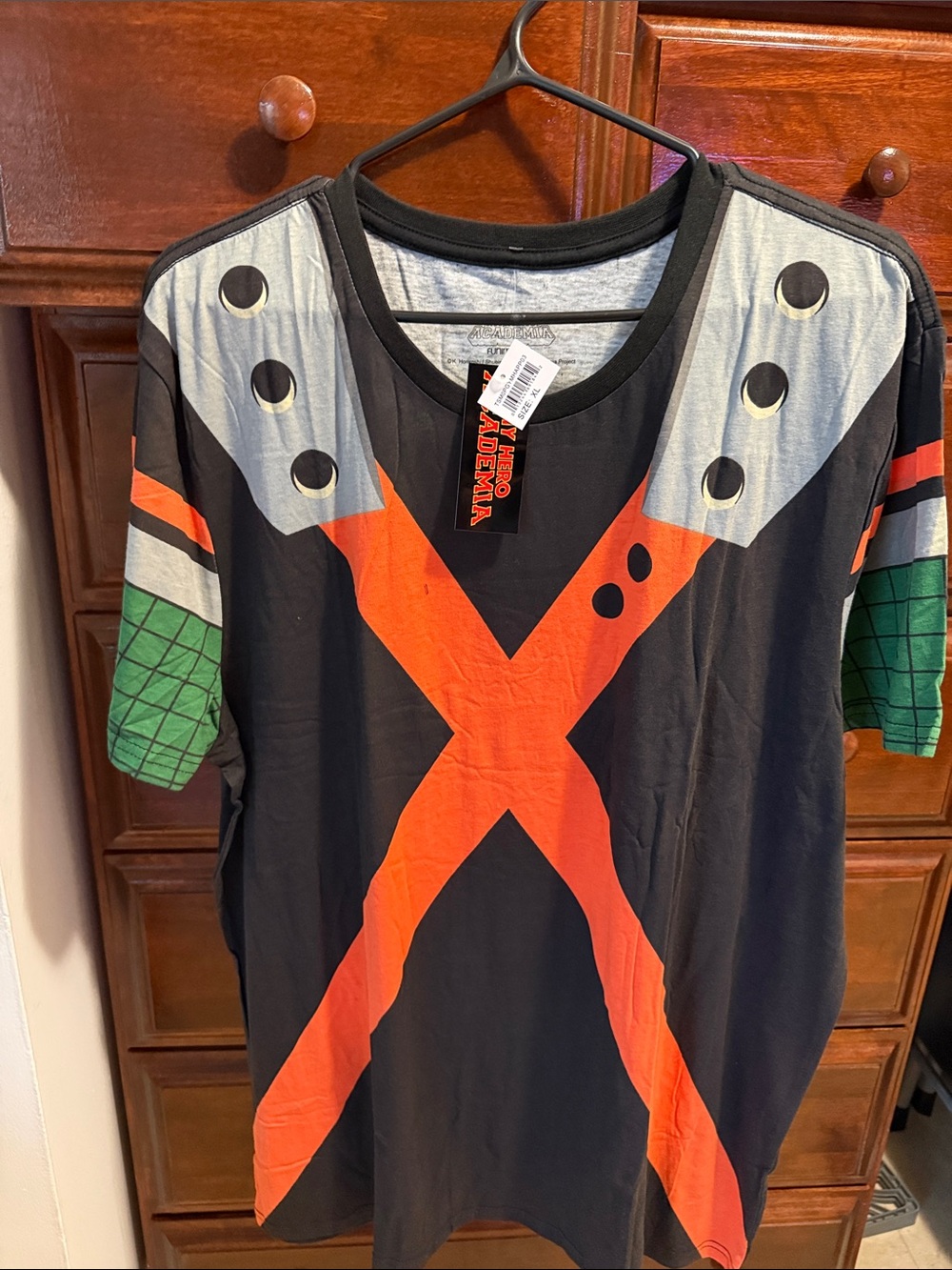Men’s Black Graphic Tee with Orange X and Green Sleeve Accents